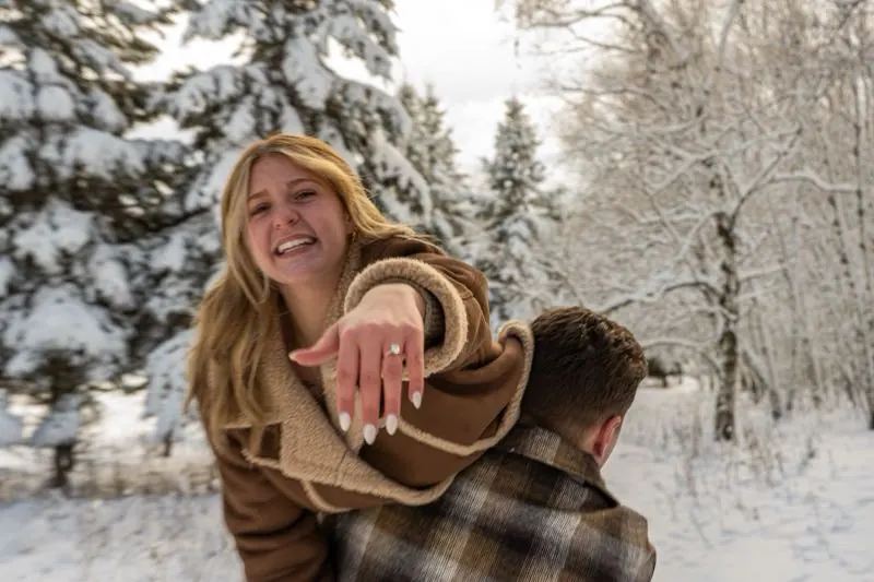 Showing off the engagement ring in the snow